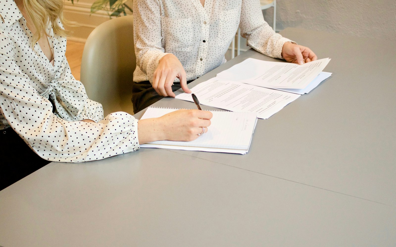 Two people reviewing documents at a table, the kind of meeting that happens during an injury lawyer free consultation