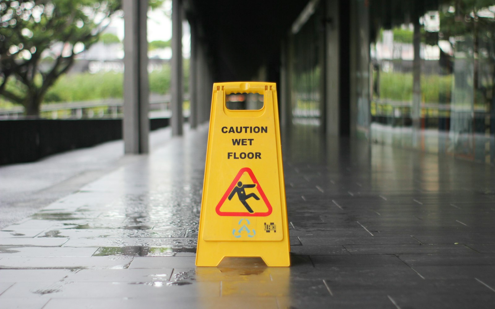 Wet floor sign in a store aisle, the kind of hazard slip and fall accident lawyers in Rosedale investigate