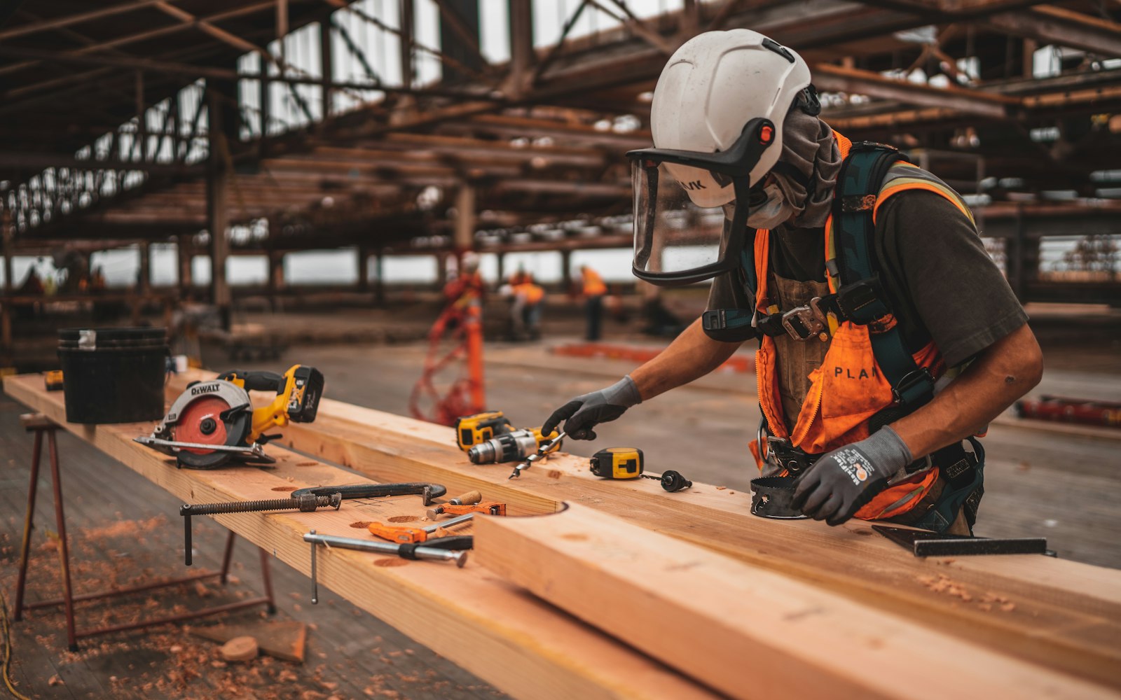 Construction worker in a hard hat and safety vest, the kind of job where workers' compensation lawyers often find a third-party claim