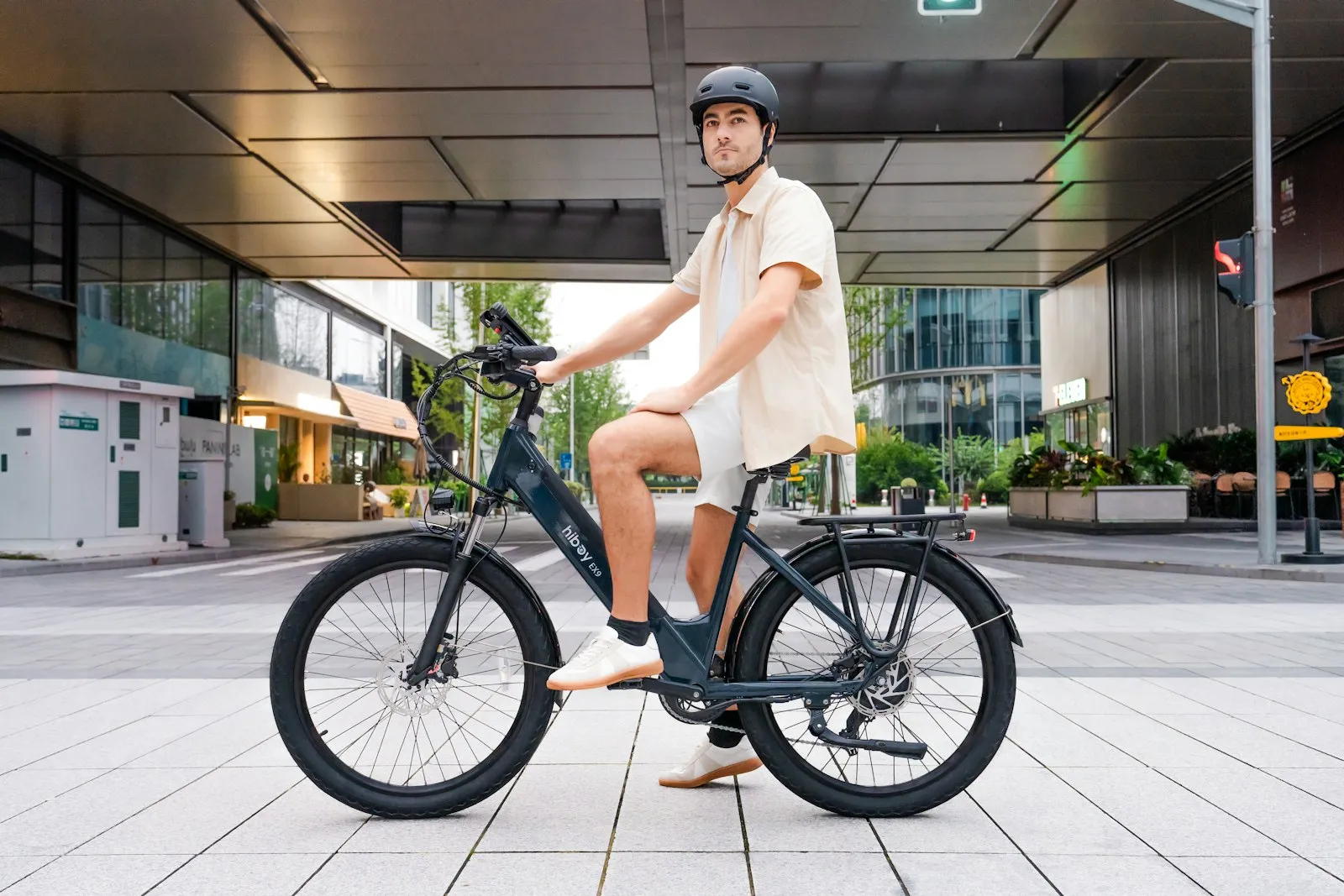 Helmeted man sitting on an electric bicycle, featured by an e-bike accident lawyer for Breezy Point