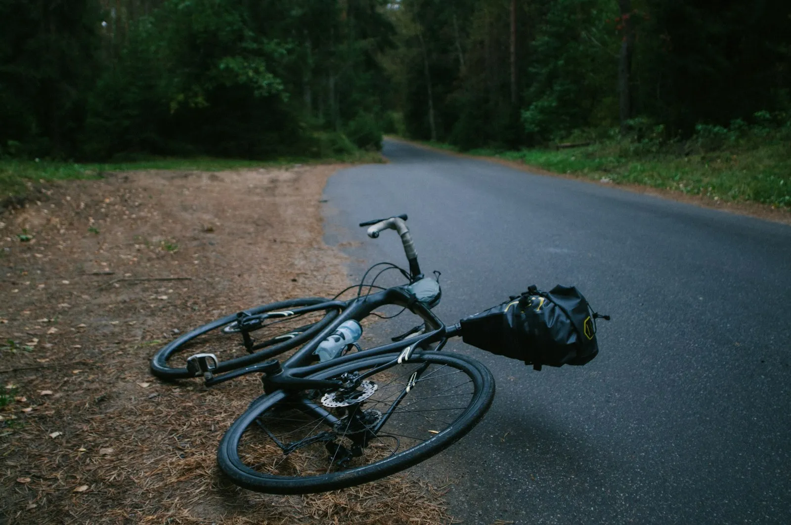 Beechhurst e-bike accident lawyer photo of a bicycle lying on its side on asphalt