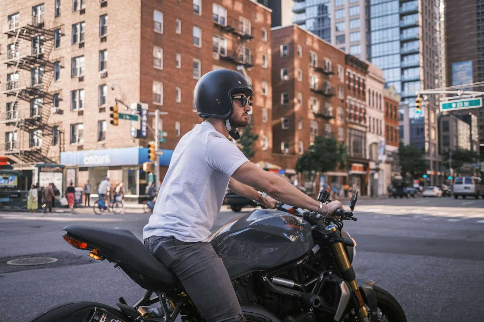 Motorcyclist wearing a helmet riding on a New York City street