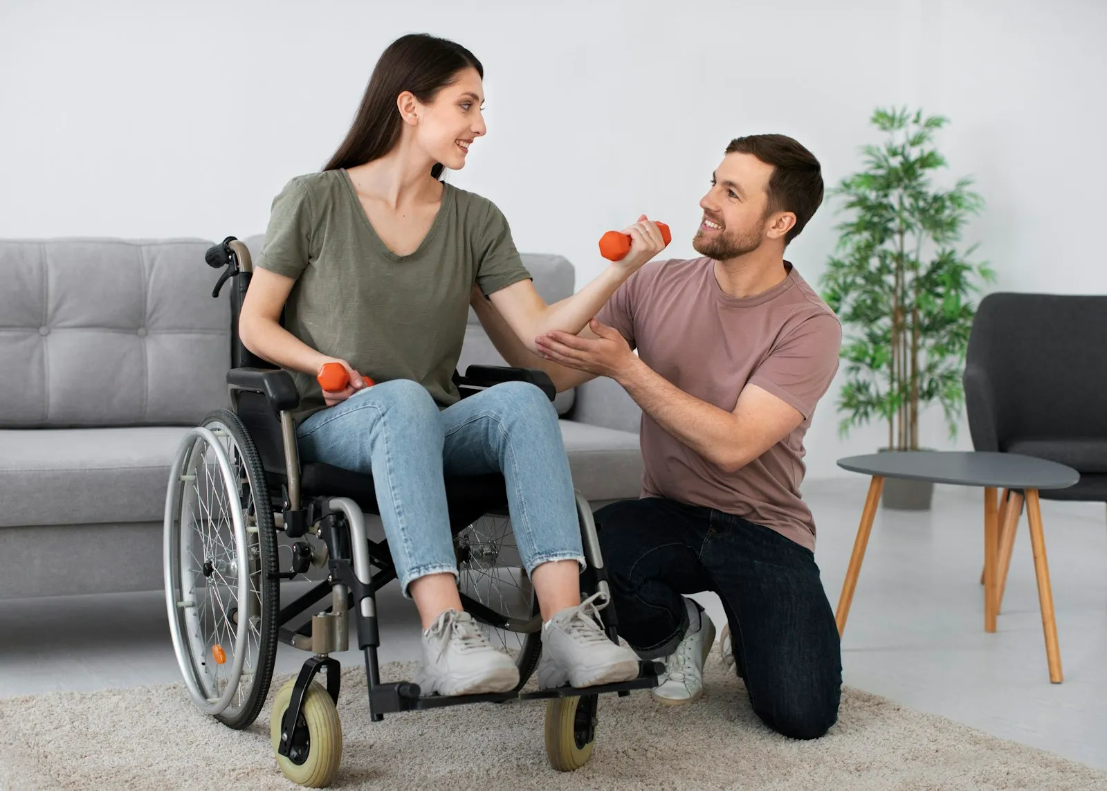 Queens spinal cord injury lawyer: woman in a wheelchair doing rehabilitation exercises with a therapist