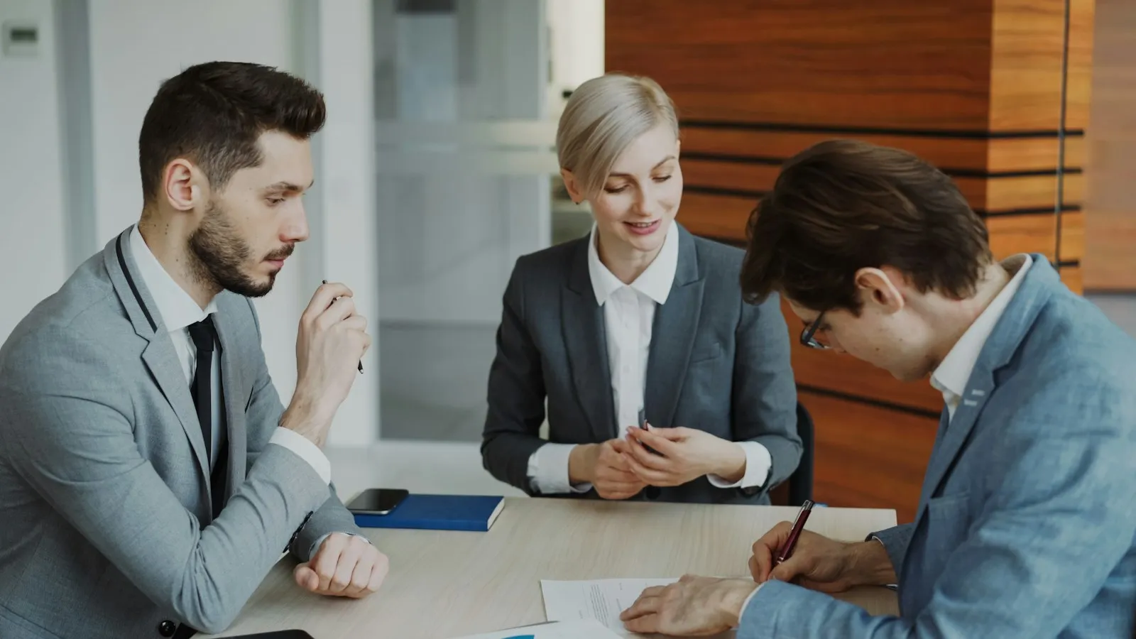 50-h hearing preparation: lawyer meeting with clients at a table to review a claim