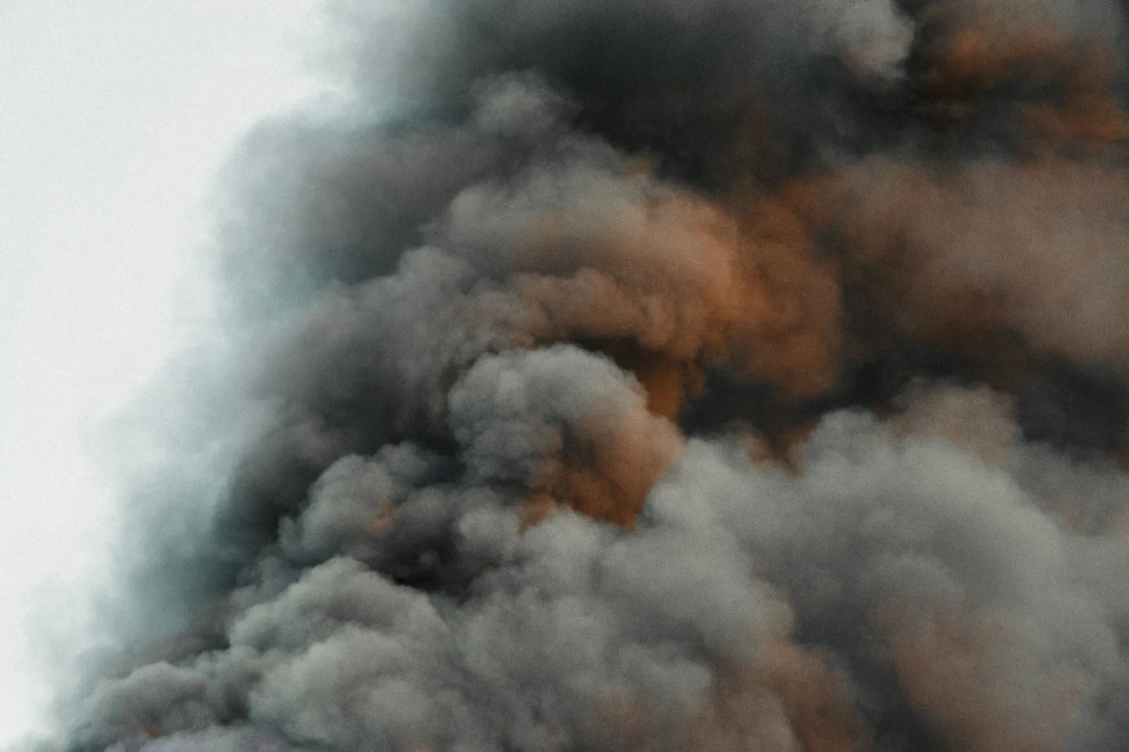 Burn injury lawyer Queens: thick dark smoke rising from a fire
