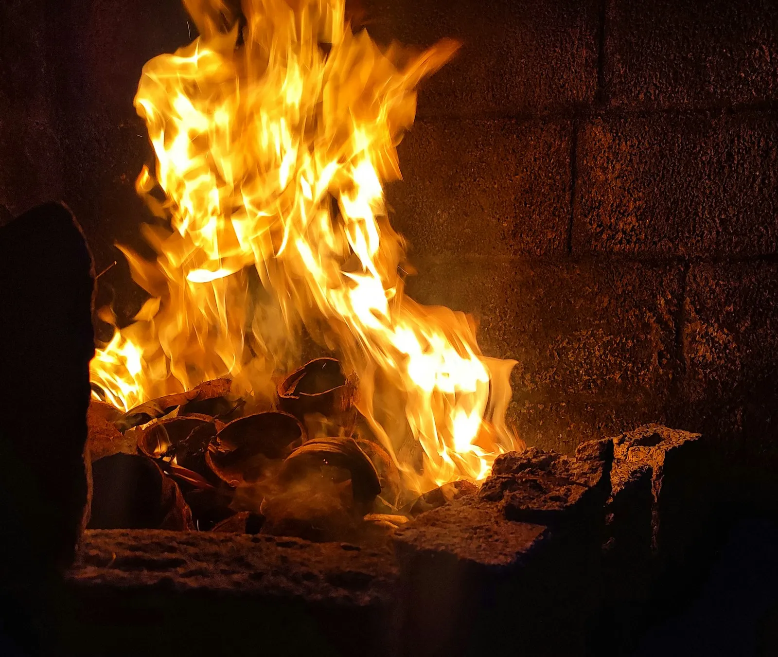 Wood fire burning in a fireplace, where a blocked flue can create carbon monoxide risks an attorney may examine