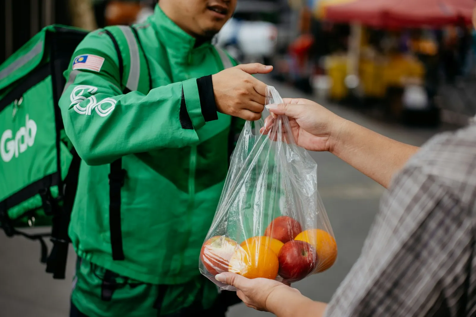 Delivery Driver Accident Lawyer in Bellerose – courier handing a food delivery bag to a customer