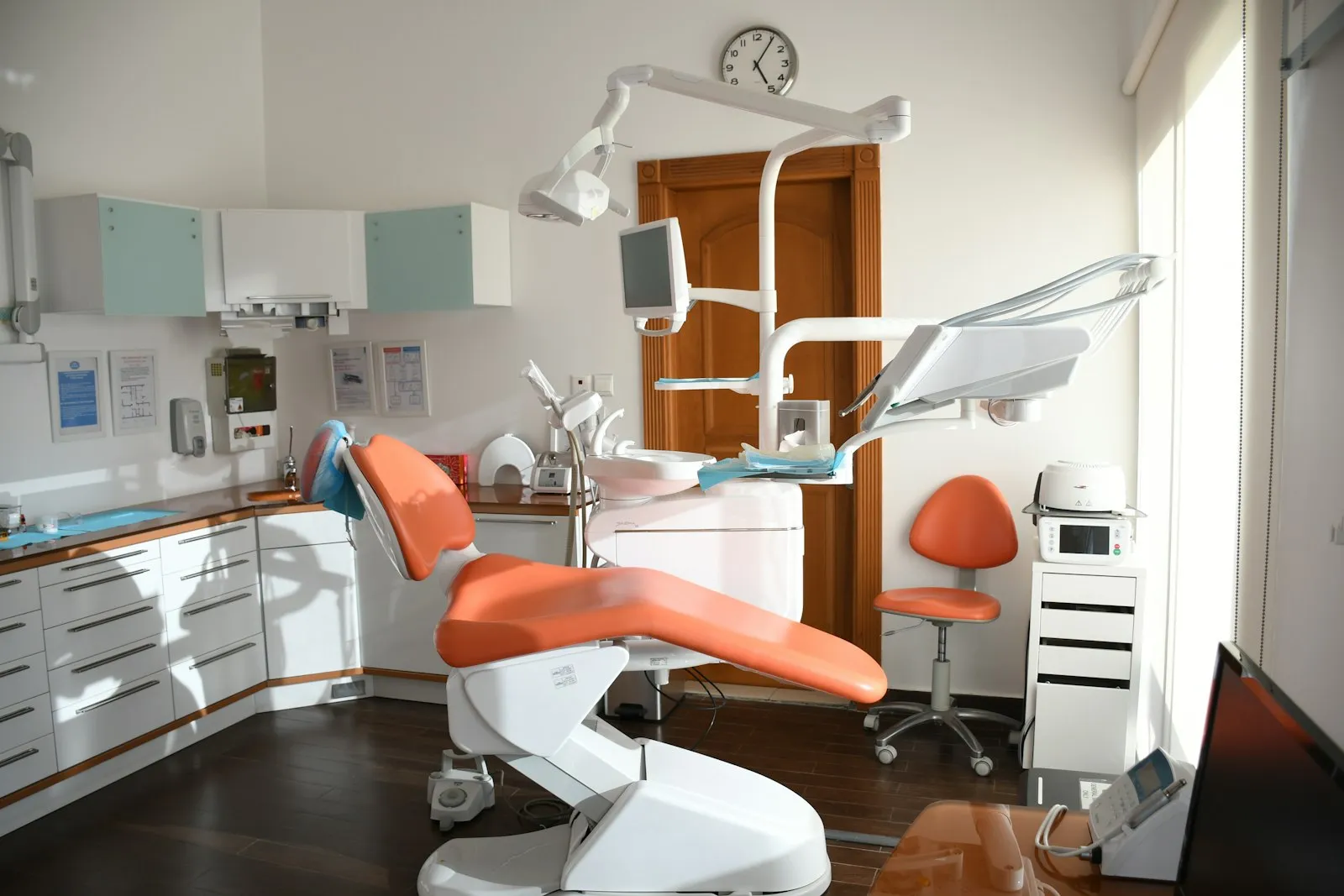 Empty dental treatment room with an orange dental chair, for a dental injury attorney article on long-term care
