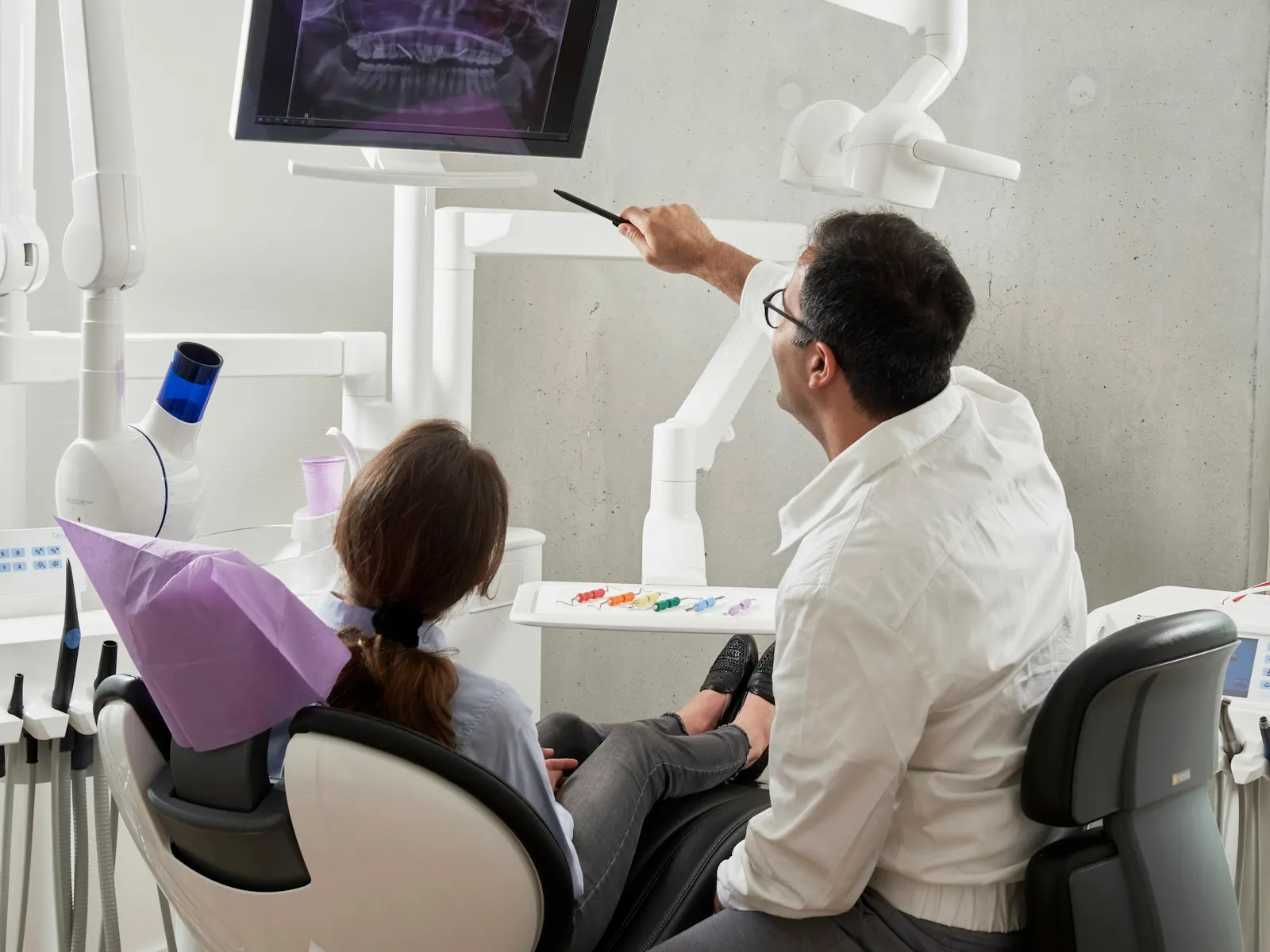 Dentist examining a patient seated in a dental chair, illustrating a dental injury lawyer guide to accident claims
