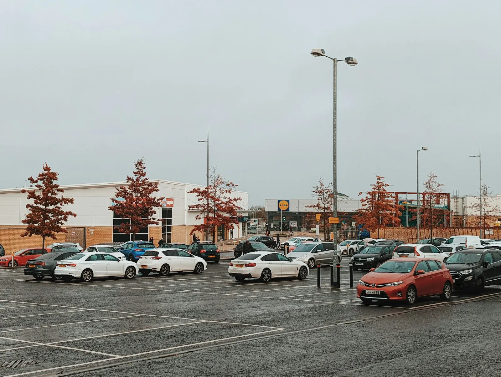 Cars parked in a large parking lot under an overcast sky, a common setting for crashes an Elmont attorney reviews