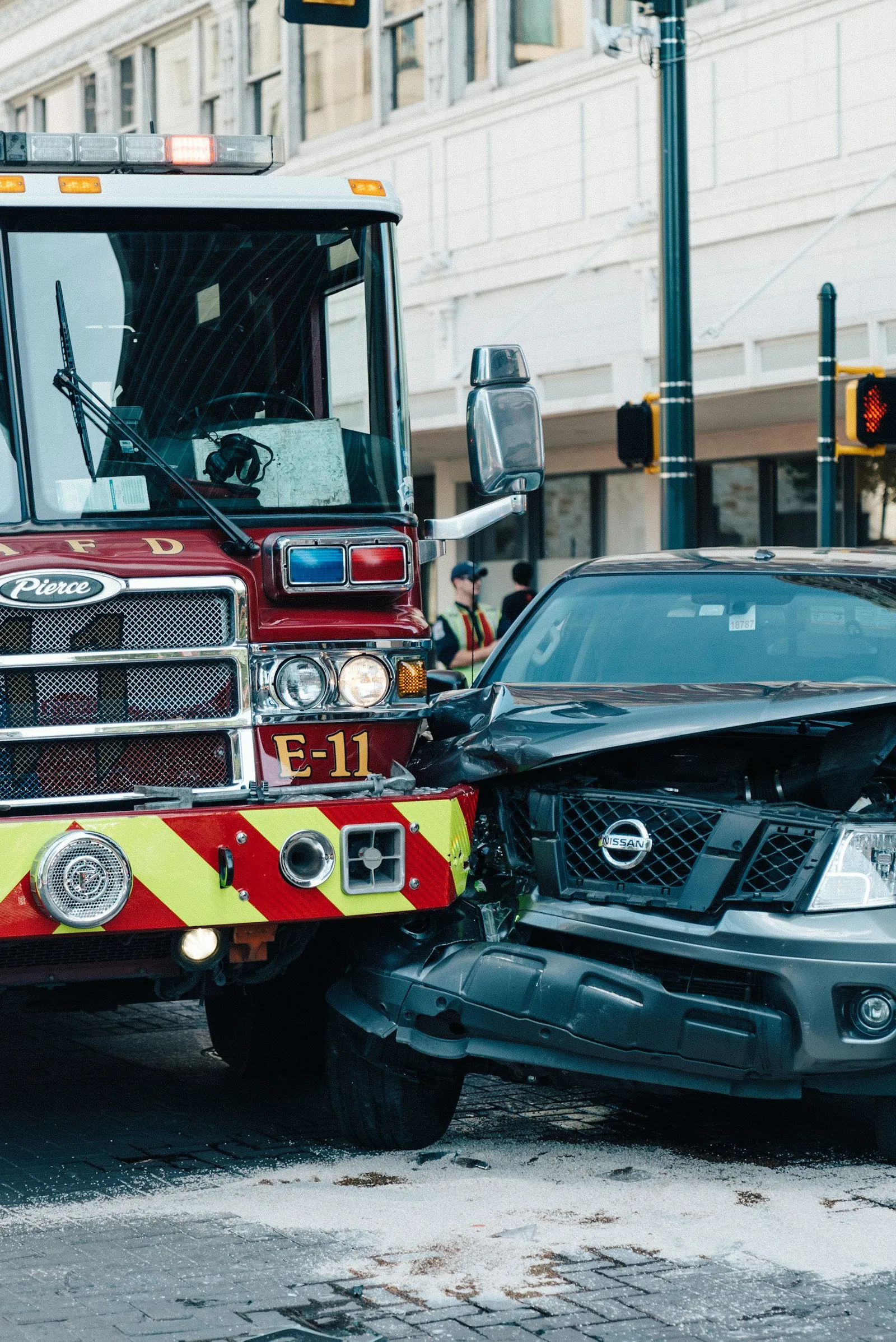 Fire truck parked beside a damaged pickup truck at a crash scene after a head on collision; attorney evidence review