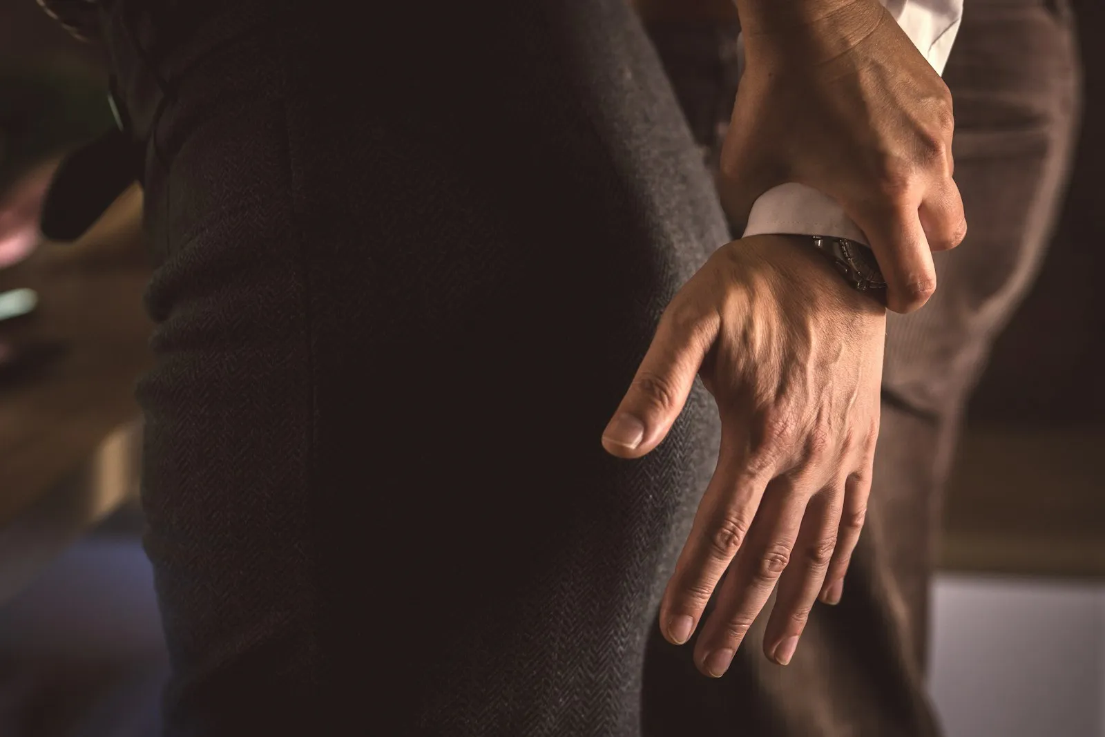 Person pressing a hand against the side of the hip, illustrating a claim a hip injury lawyer may handle