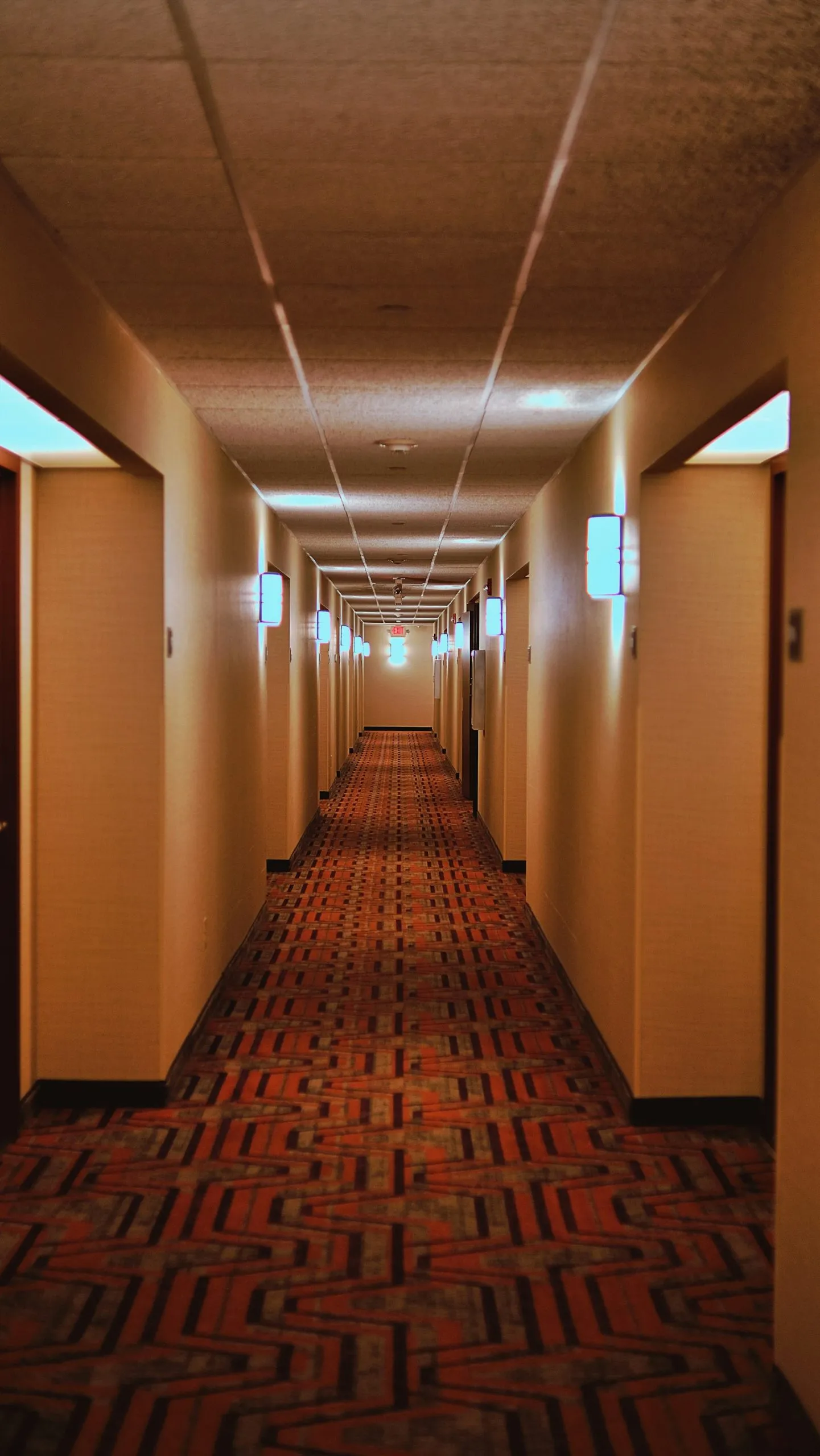 Long carpeted hotel hallway lined with room doors, a common setting for hotel injury lawyer cases
