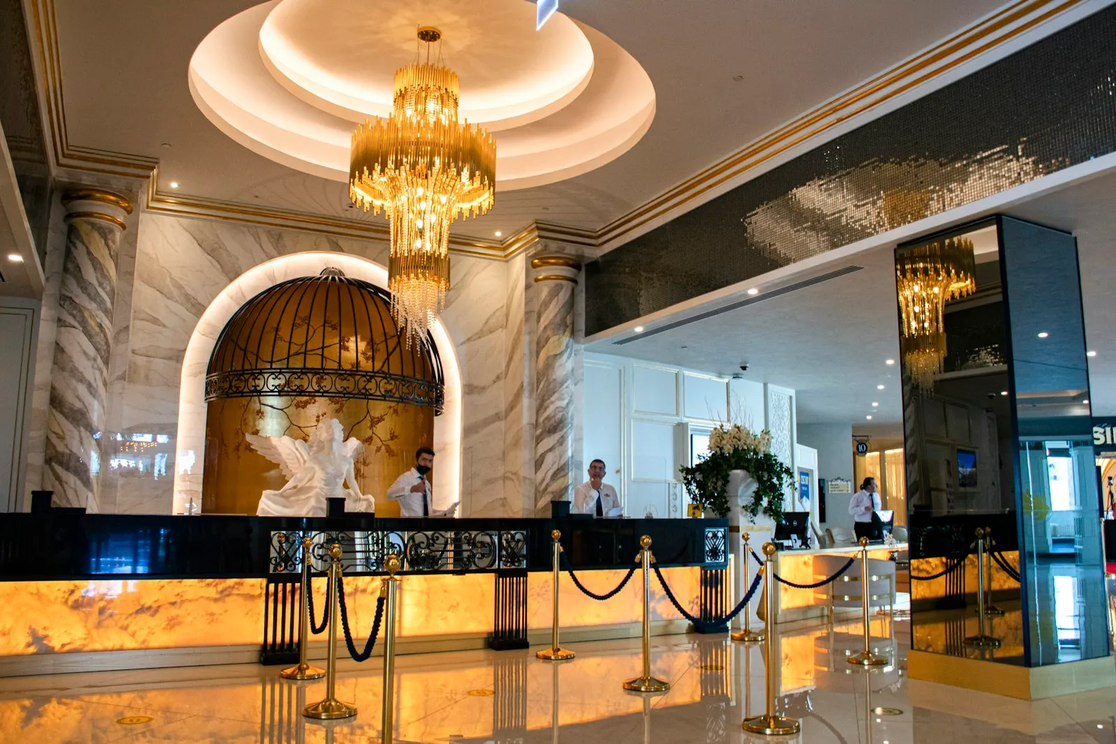 Hotel lobby with a front desk and chandelier, where a hotel injury attorney may request incident reports