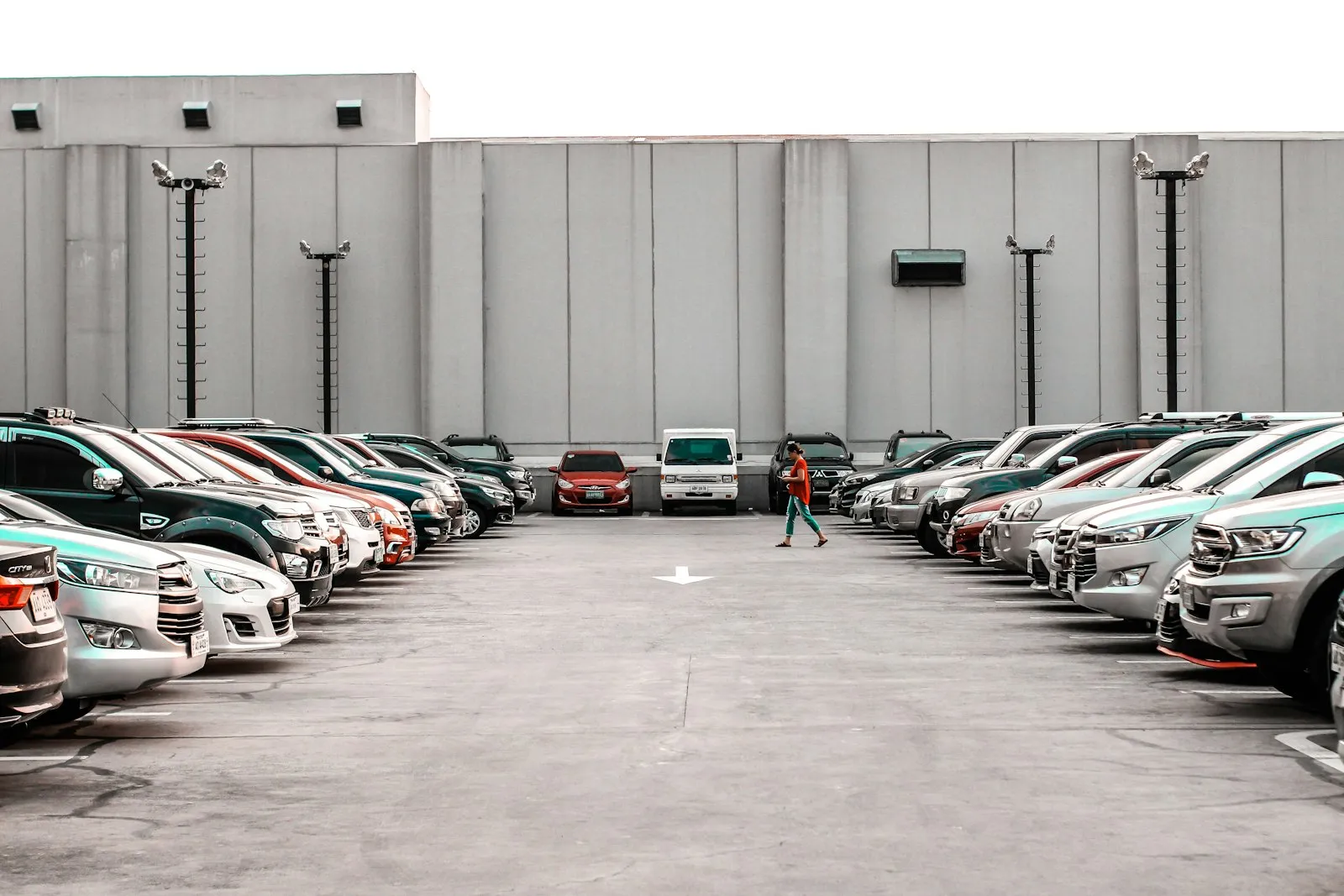 Cars parked in rows outside a large windowless store building, typical of cases a parking lot accident lawyer handles
