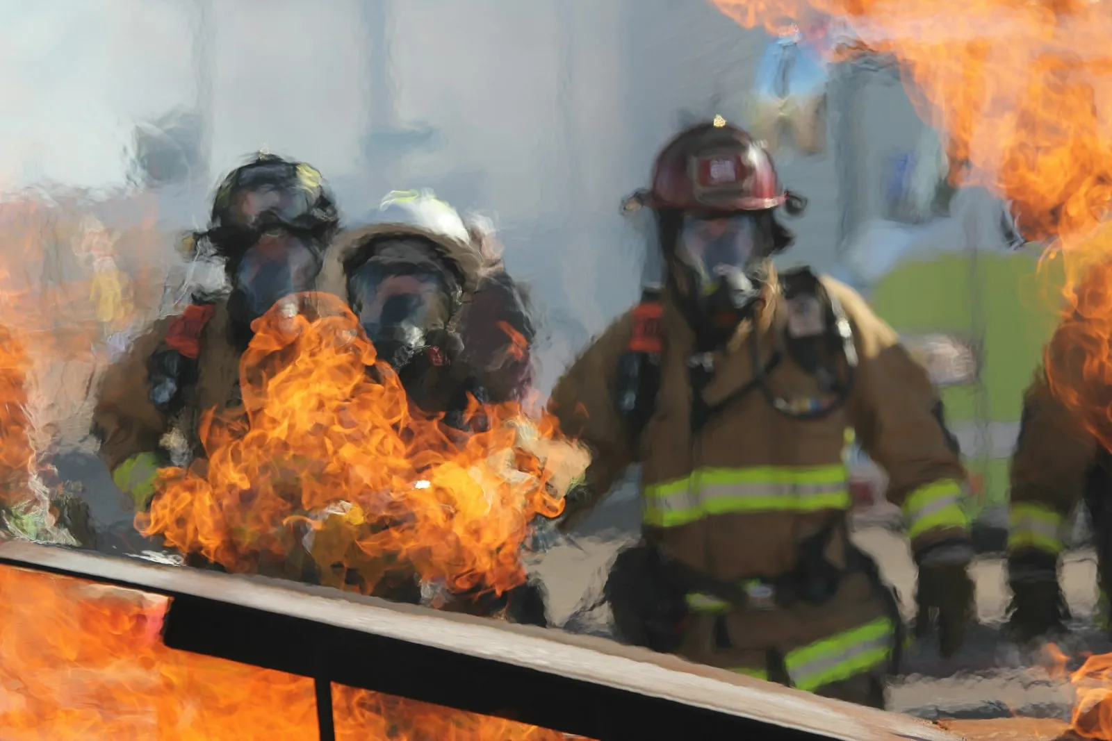 Queens burn injury lawyer: firefighters in protective gear working near open flames