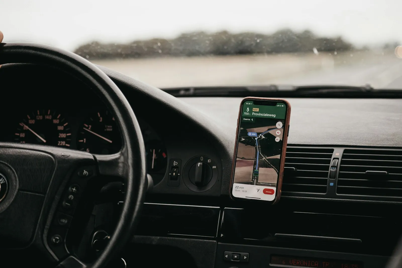 Smartphone in a dashboard mount inside a vehicle
