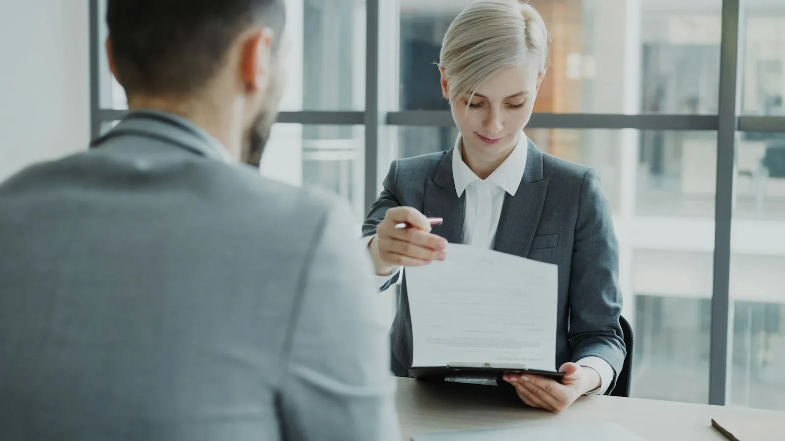 Professional showing a document to a client