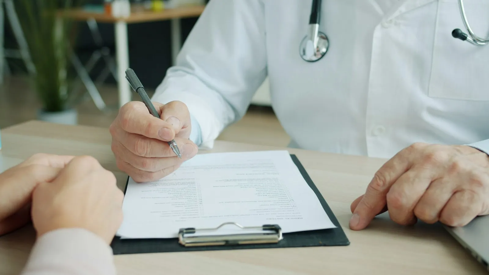 Doctor writing in a patient's chart