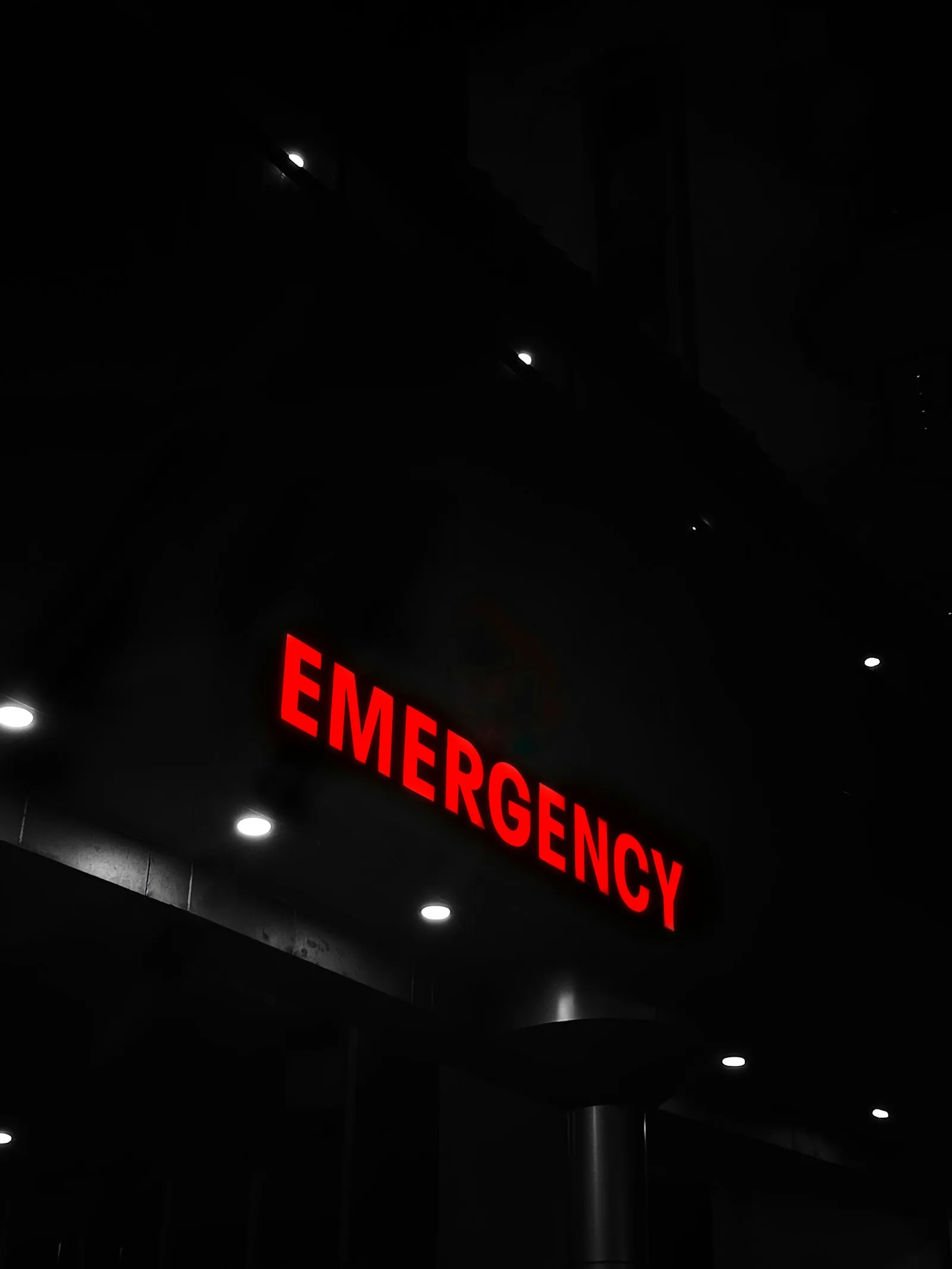 Emergency department entrance sign lit at night
