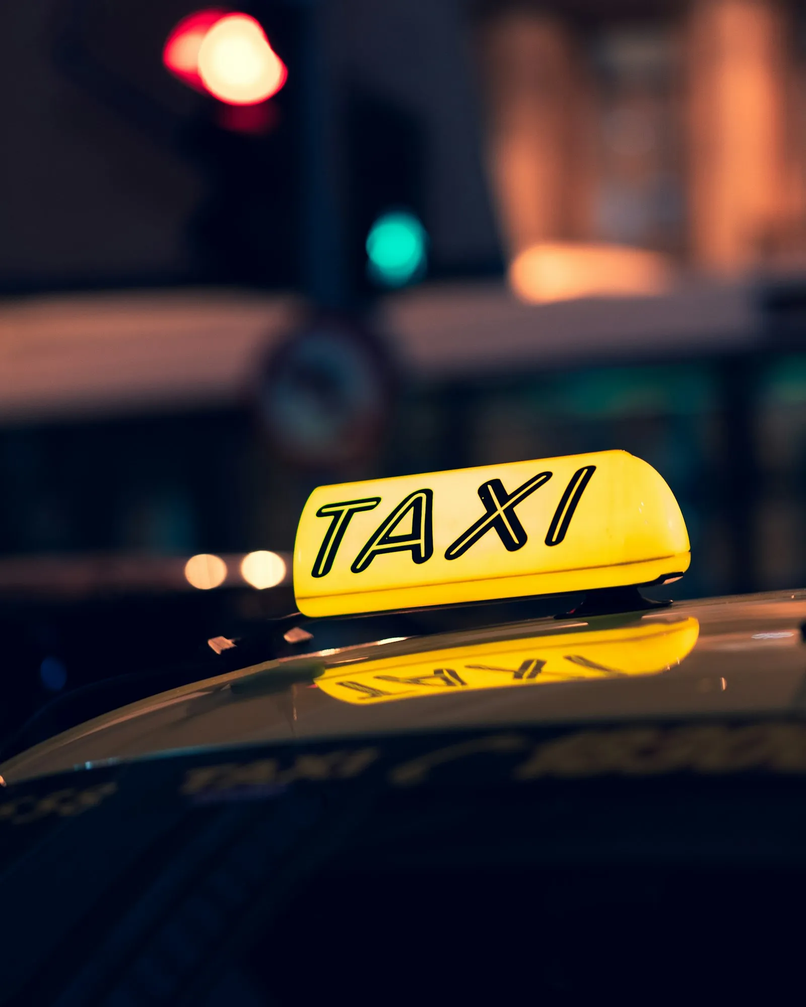 Yellow taxi cab on the road at night