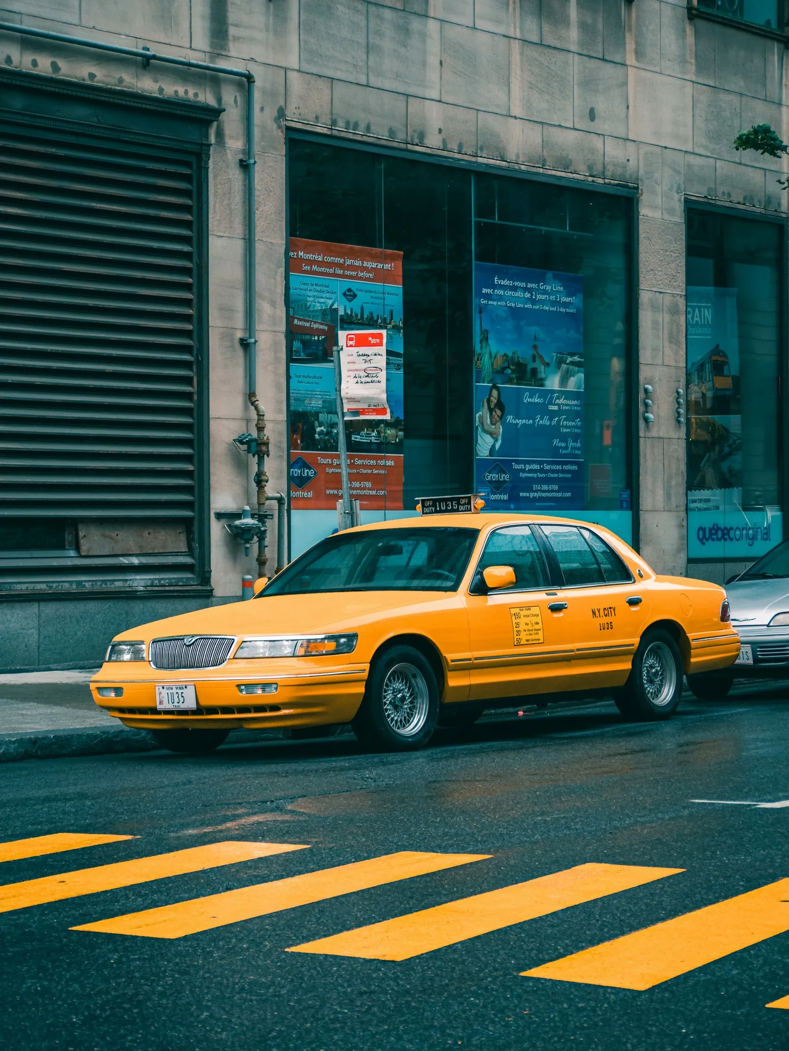 Yellow taxi on a city street in daylight