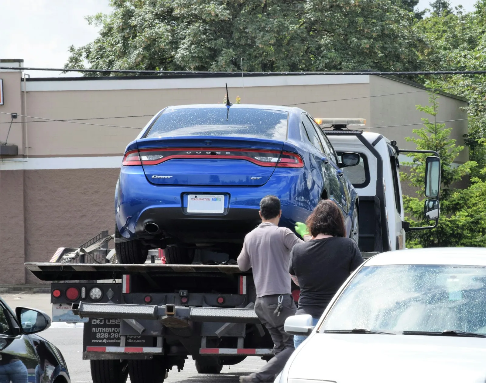 Car being loaded onto a flatbed truck