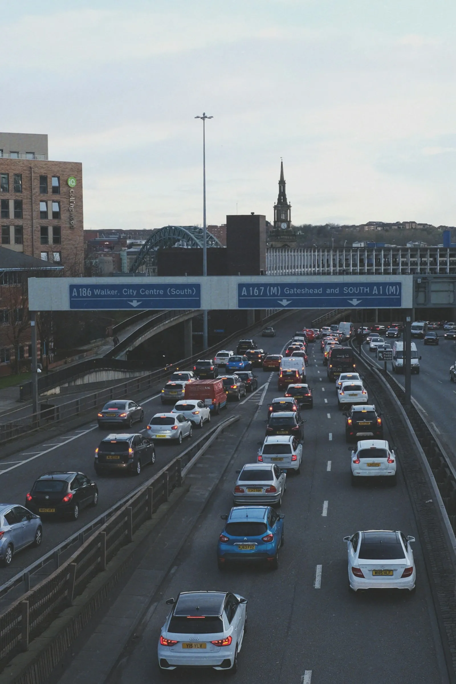 Cars on a road near a bridge