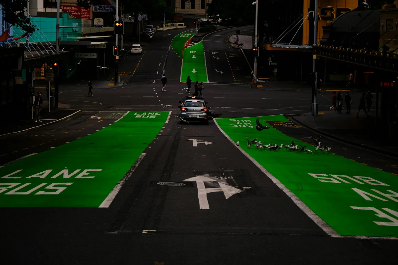 Car driving down a city street with painted lane markings