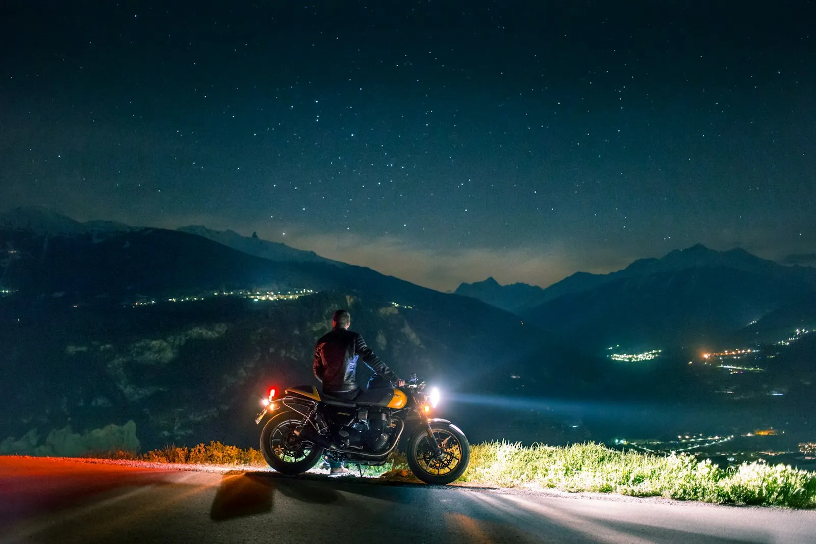 Motorcycle rider sitting on a bike at night