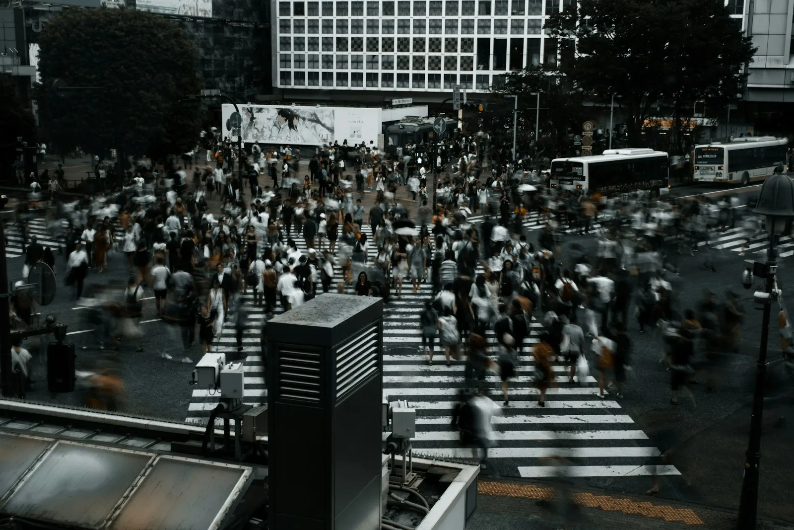 Pedestrians crossing a busy city street in a crosswalk
