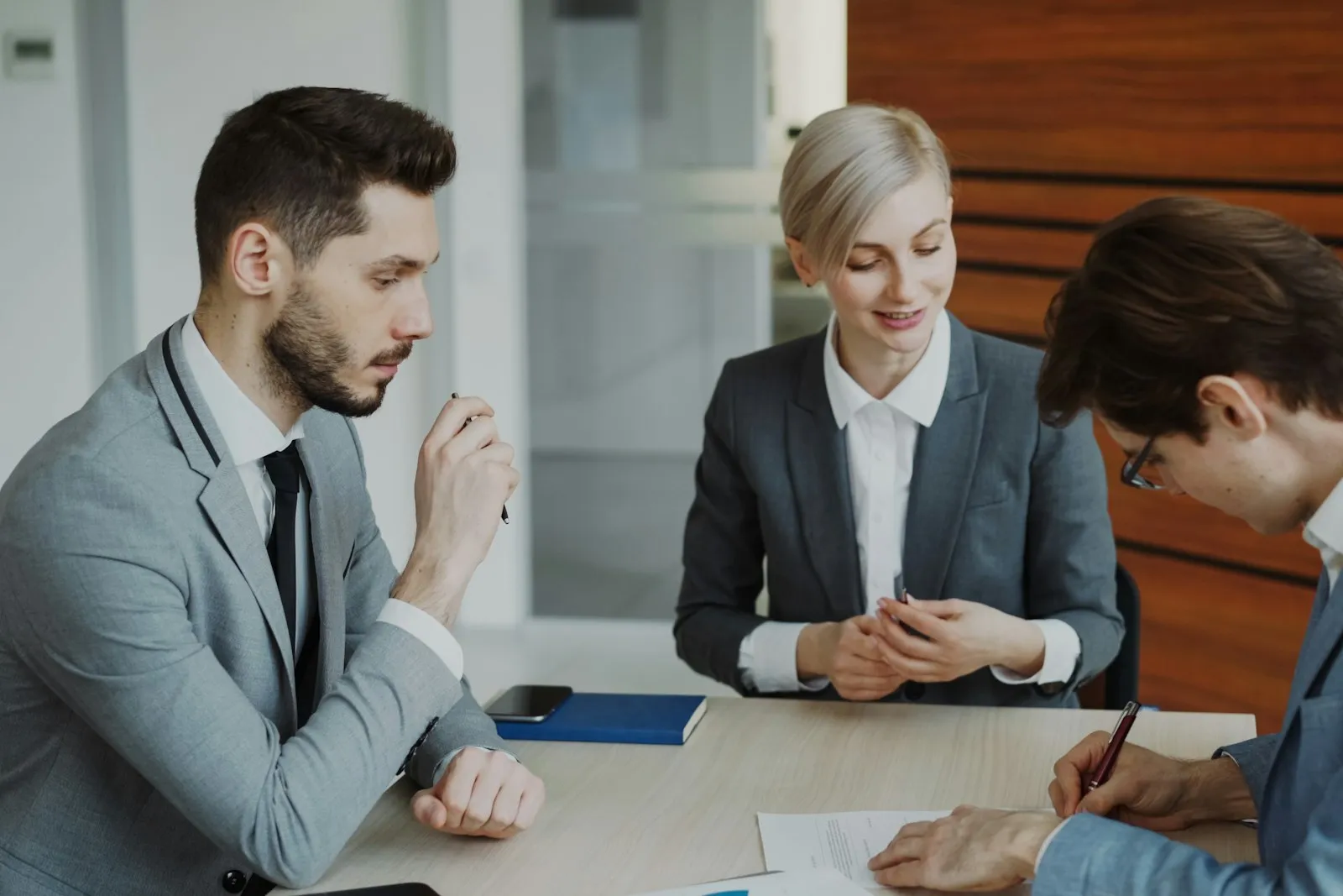 Client reviewing and signing paperwork with an attorney