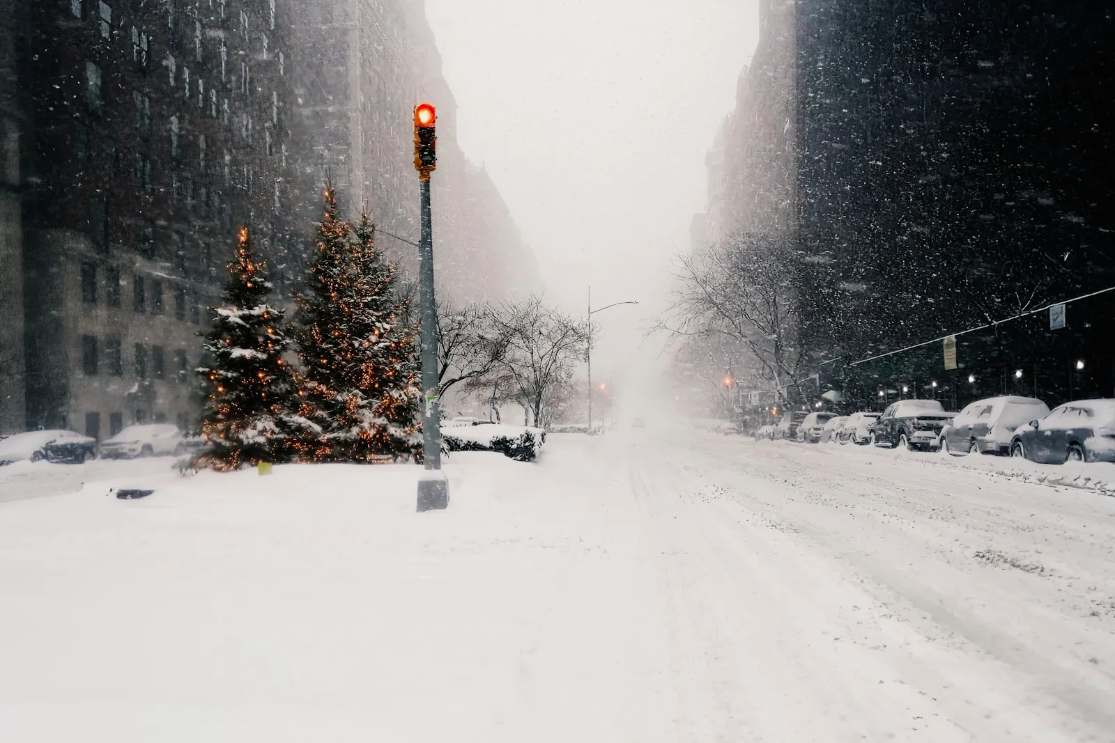 Snow-covered city street at a traffic light