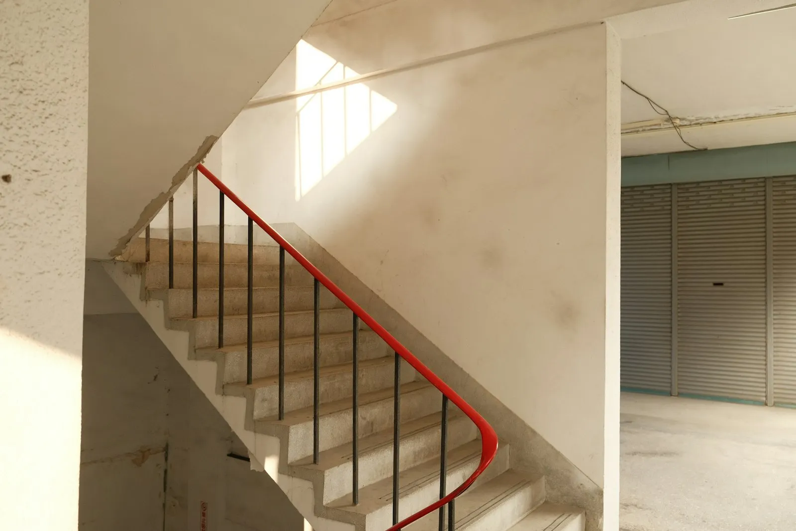 Staircase with a red handrail