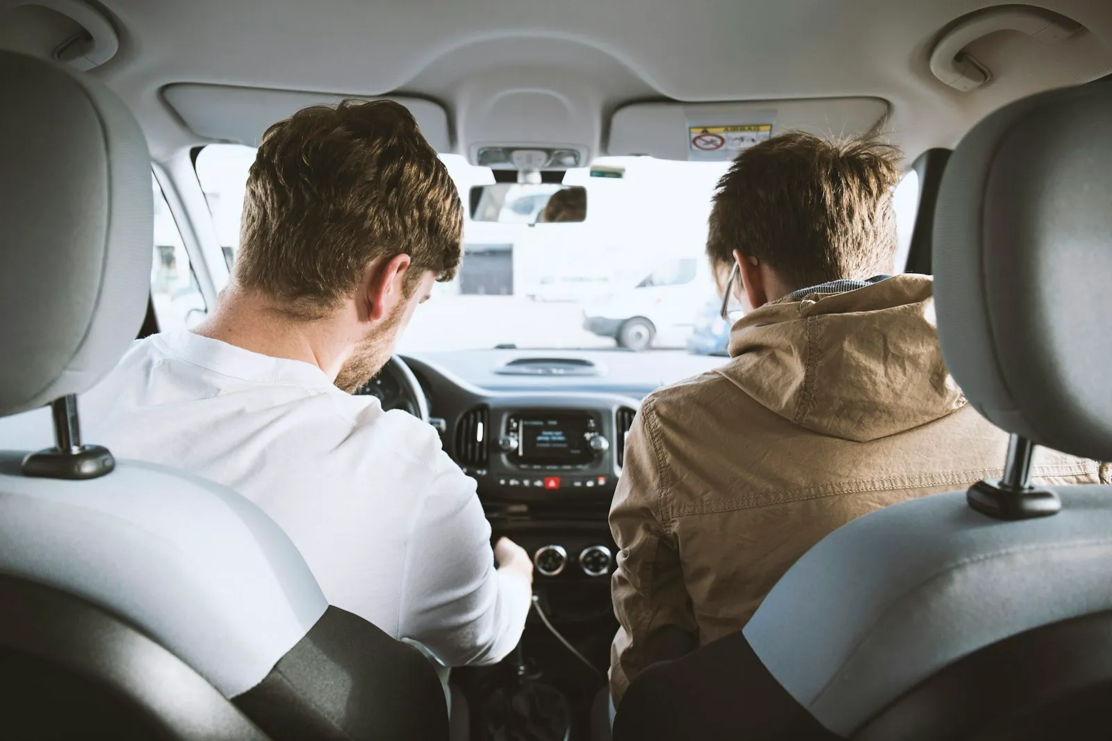 Two men sitting inside a car