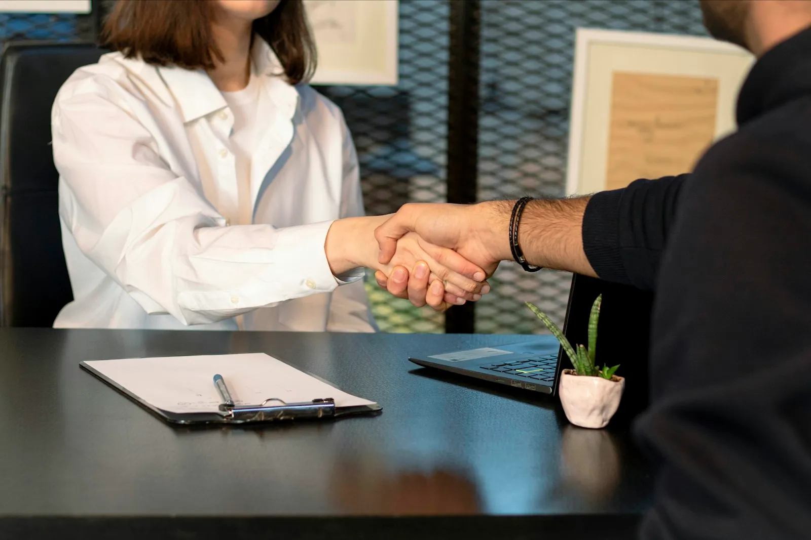 Two people shaking hands after a meeting