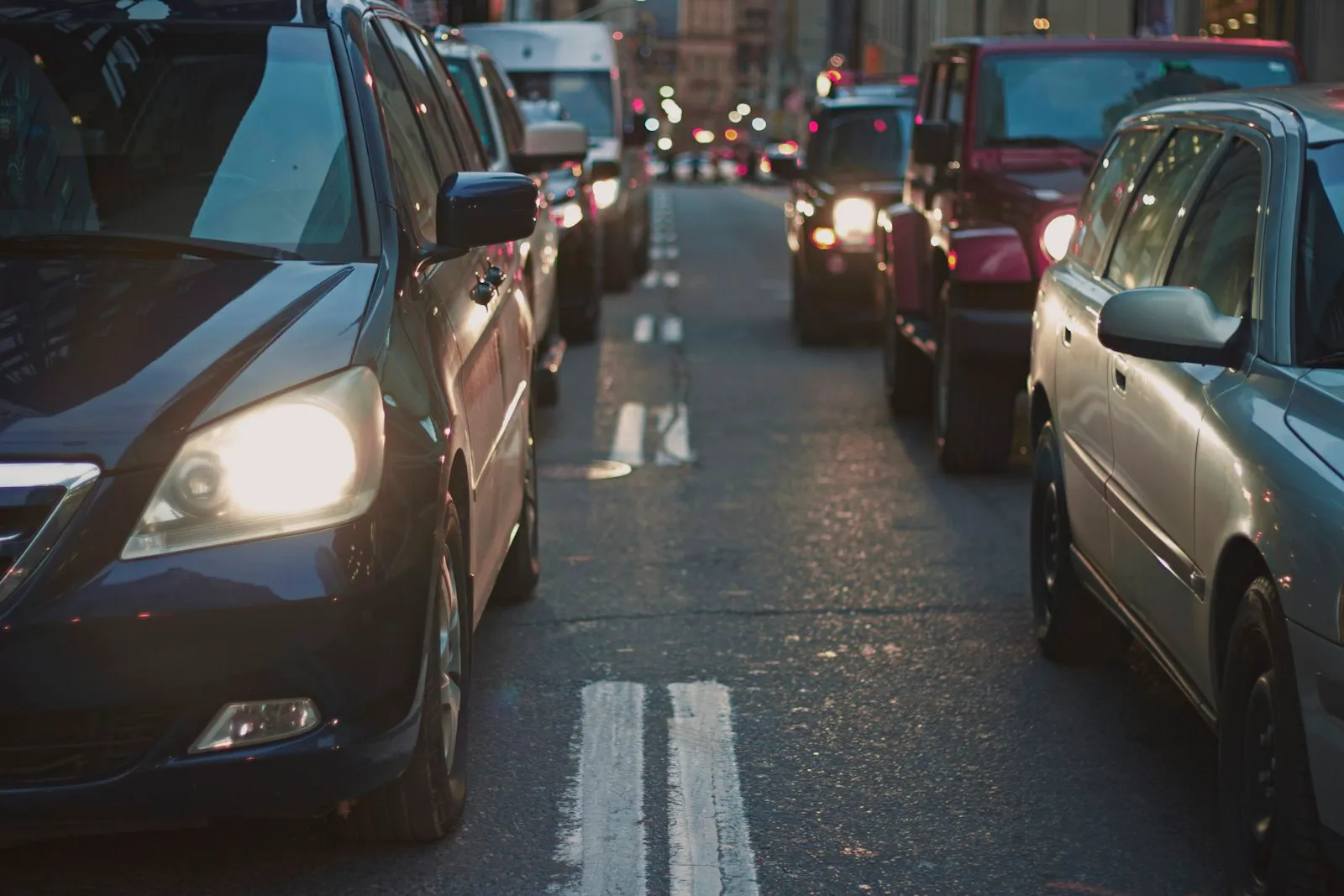 Cars packed bumper to bumper in slow city traffic, where a road rage accident lawyer often sees tempers flare