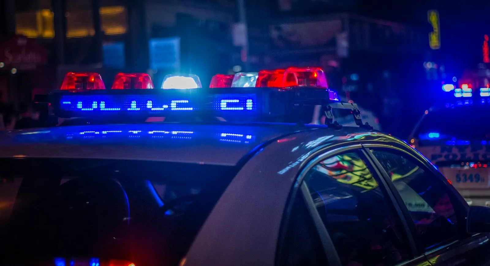 Scooter Accident Lawyer in Bellerose – police car with flashing lights at a crash scene