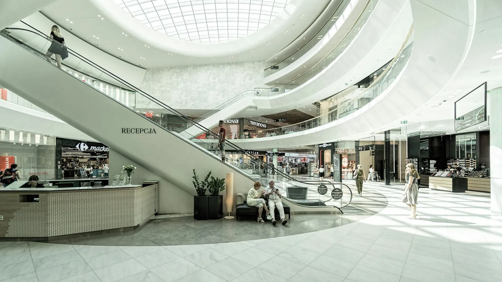 Interno di un centro commerciale luminoso a più livelli con scale mobili, del tipo di spazio che un avvocato specializzato in responsabilità da locali (premises) di Valley Stream esamina