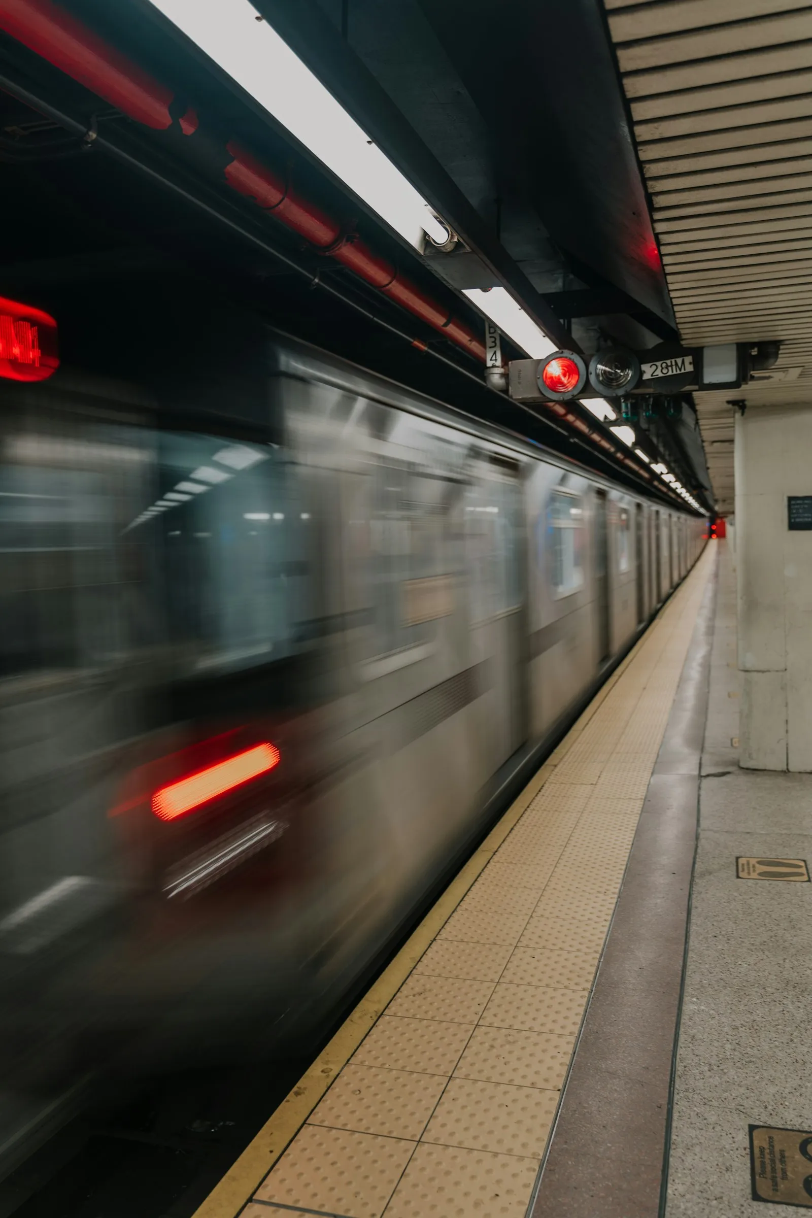 Subway accident attorney: subway train speeding past the edge of a station platform